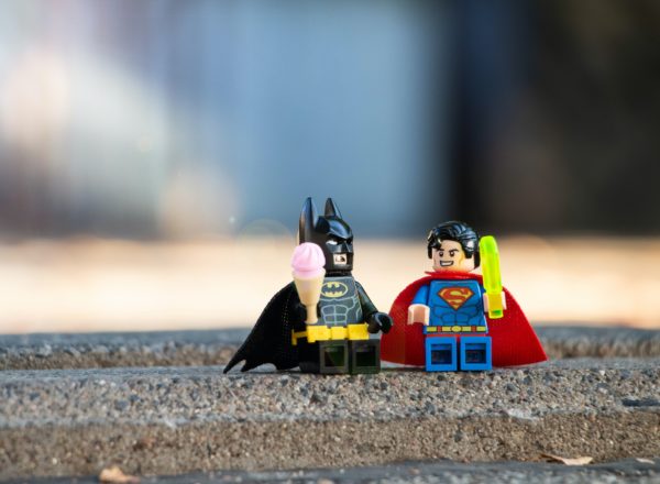 The Lego figures of Batman and Superman next to each other.