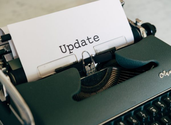 Typewriter with paper that reads 'Update'
