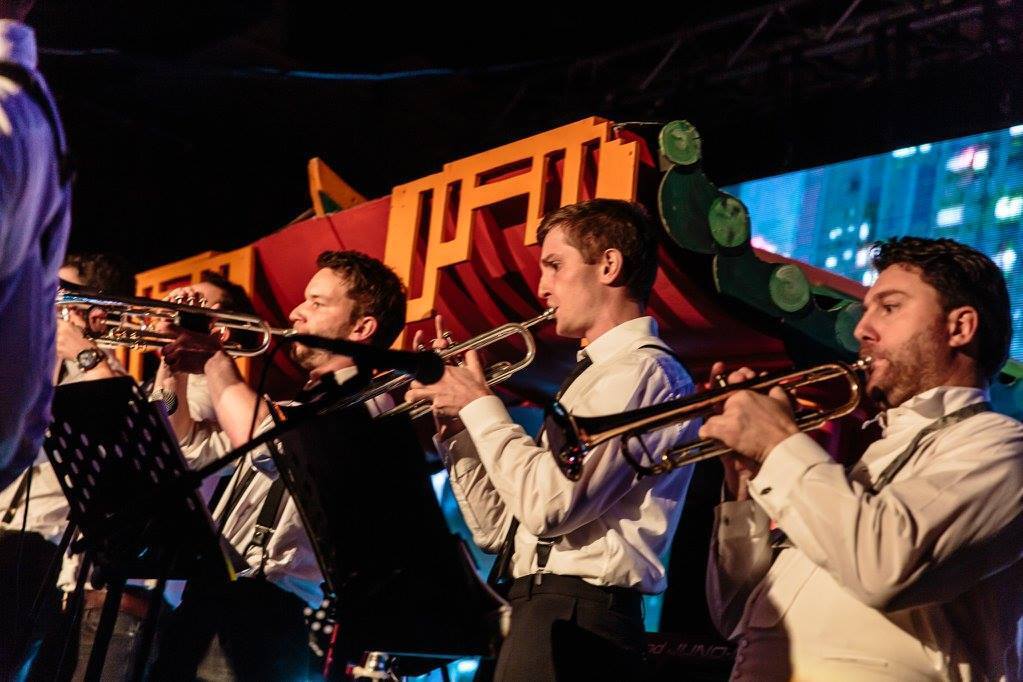 Five musicians performing at an event.